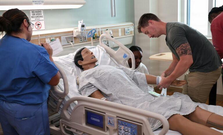 A nurse assesses an adult patient in a hospital emergency room while monitoring vital signs.